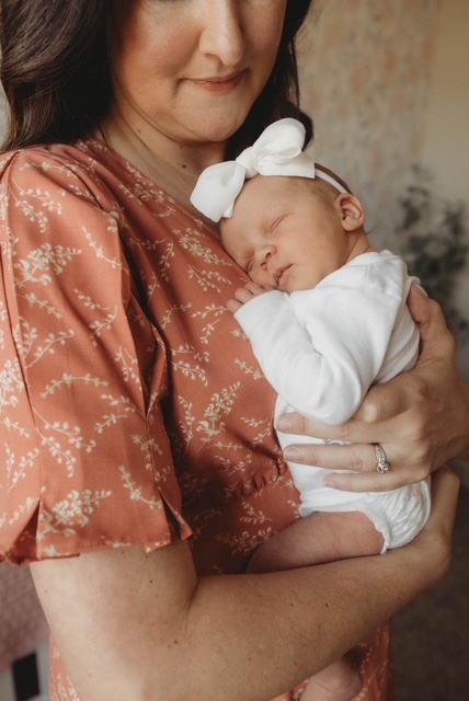 Mother holding her sleeping newborn baby